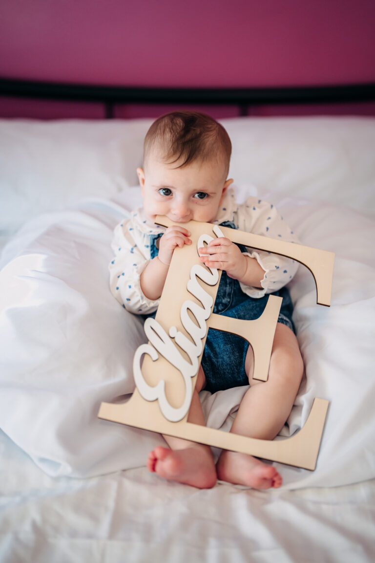 Baby portrait with personalised name sign before her christening