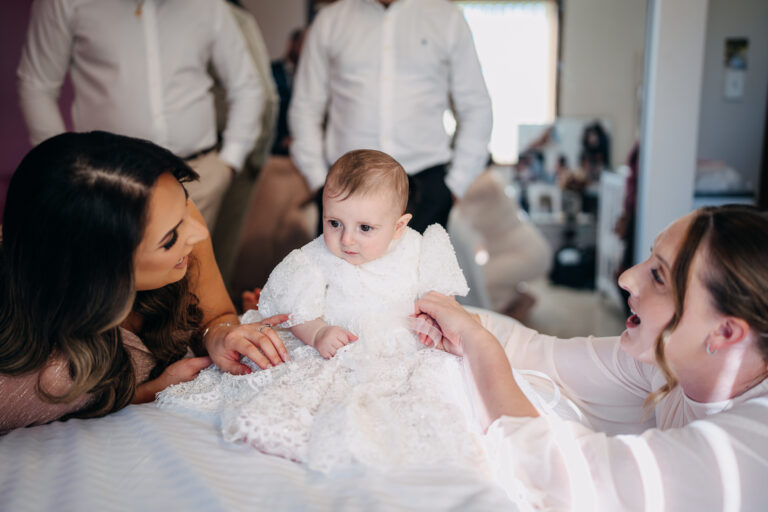 Baby with family during christening preparations in Sydney
