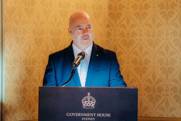 Guest speaker delivering a presentation at Government House Sydney during a formal event