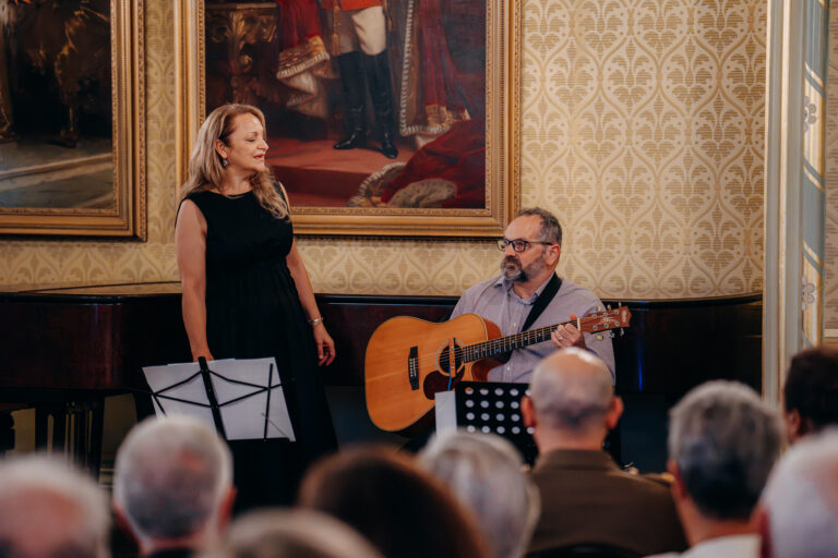 Live vocal and acoustic guitar performance during a formal event at Government House Sydney