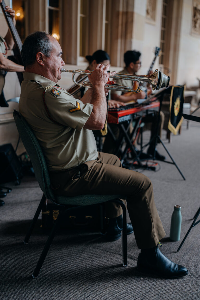 Military band musician playing trumpet during an event at Government House Sydney