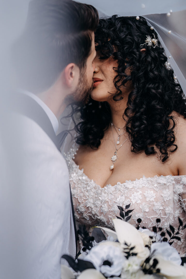Intimate wedding portrait of Jordan and Shakira embracing with soft natural light.